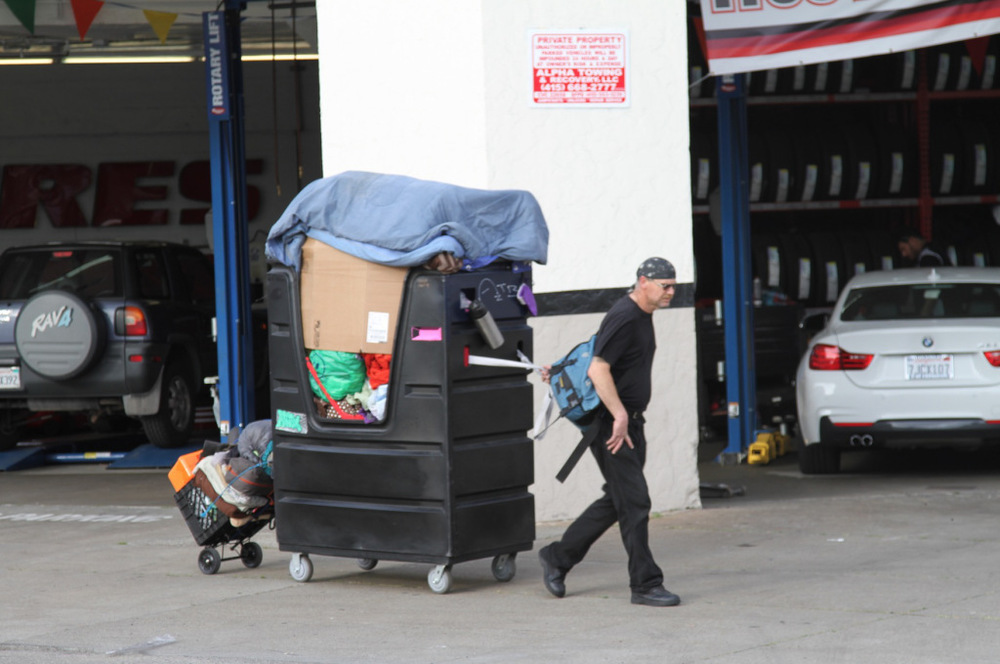a man pulling a large trolley