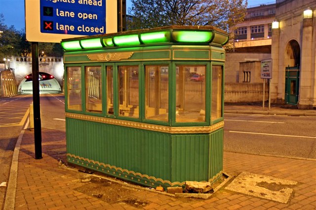 a green toll booth approaching the Queensway tunnel in Liverpool. it is late evening